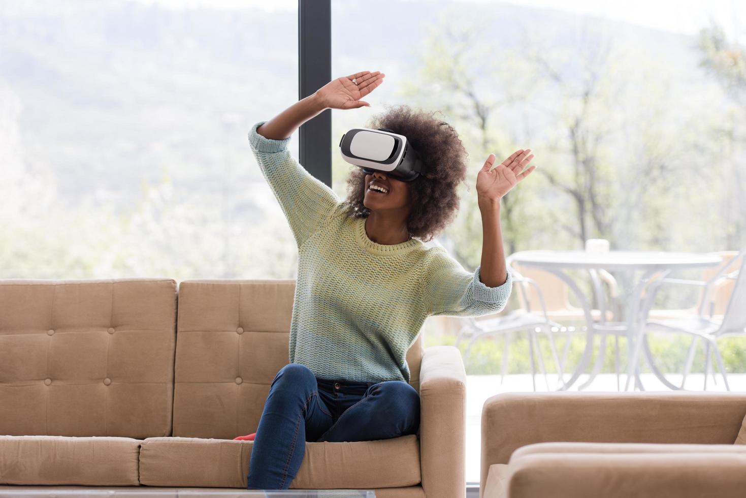 black woman using VR headset glasses of virtual reality photo