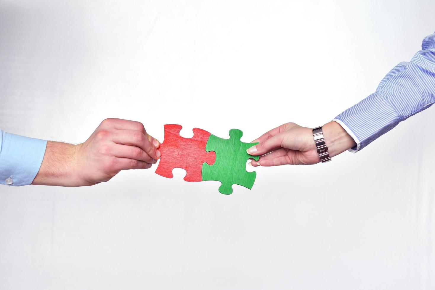 Group of business people assembling jigsaw puzzle photo