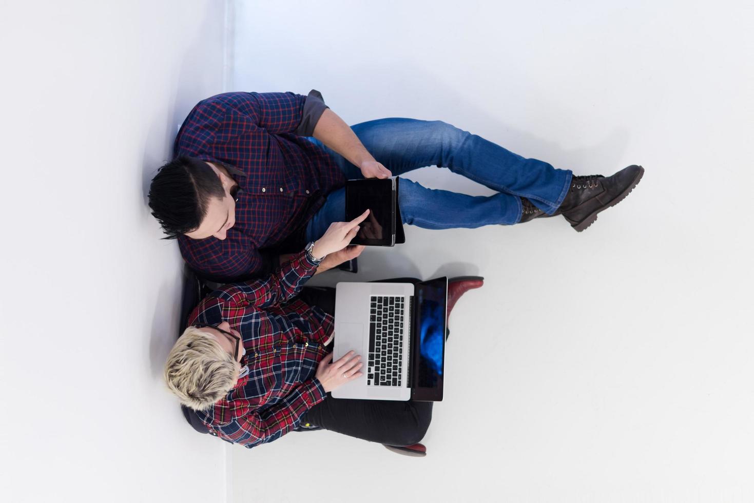 top view of  couple working on laptop computer at startup office photo