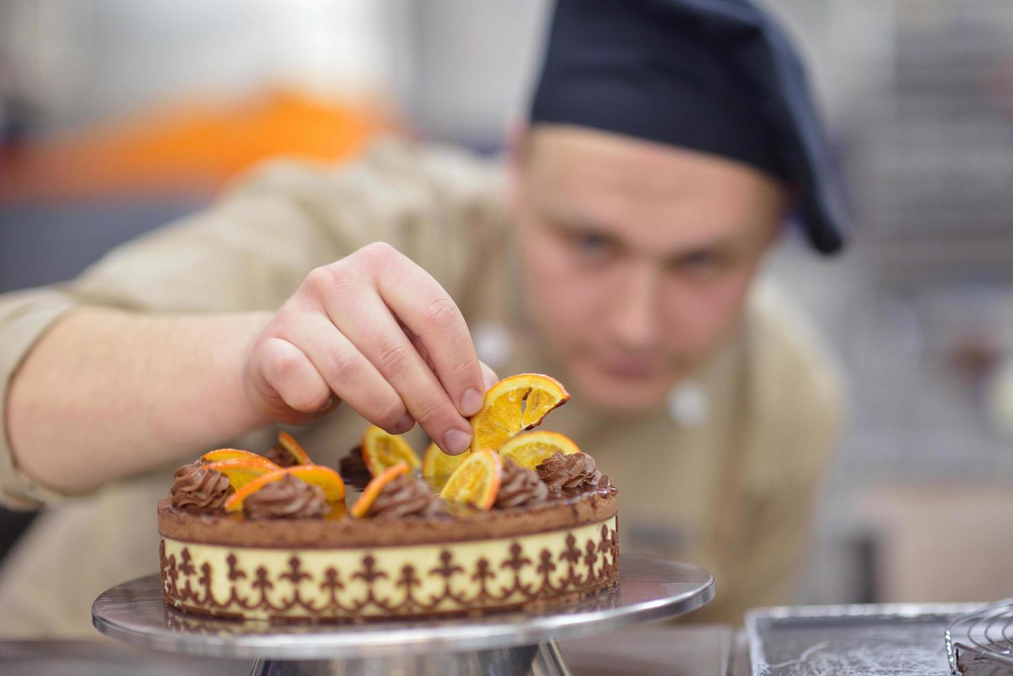 chef preparing desert cake in the kitchen photo