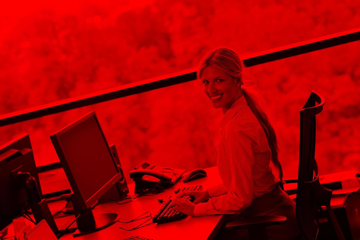 business woman working on her desk in an office photo