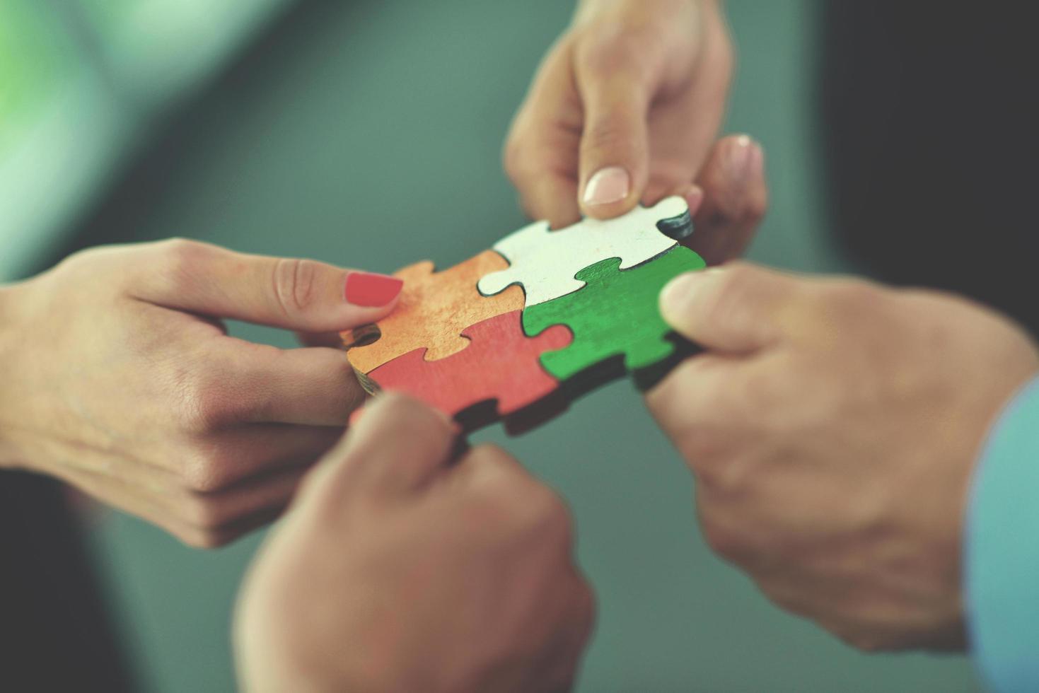 Group of business people assembling jigsaw puzzle photo