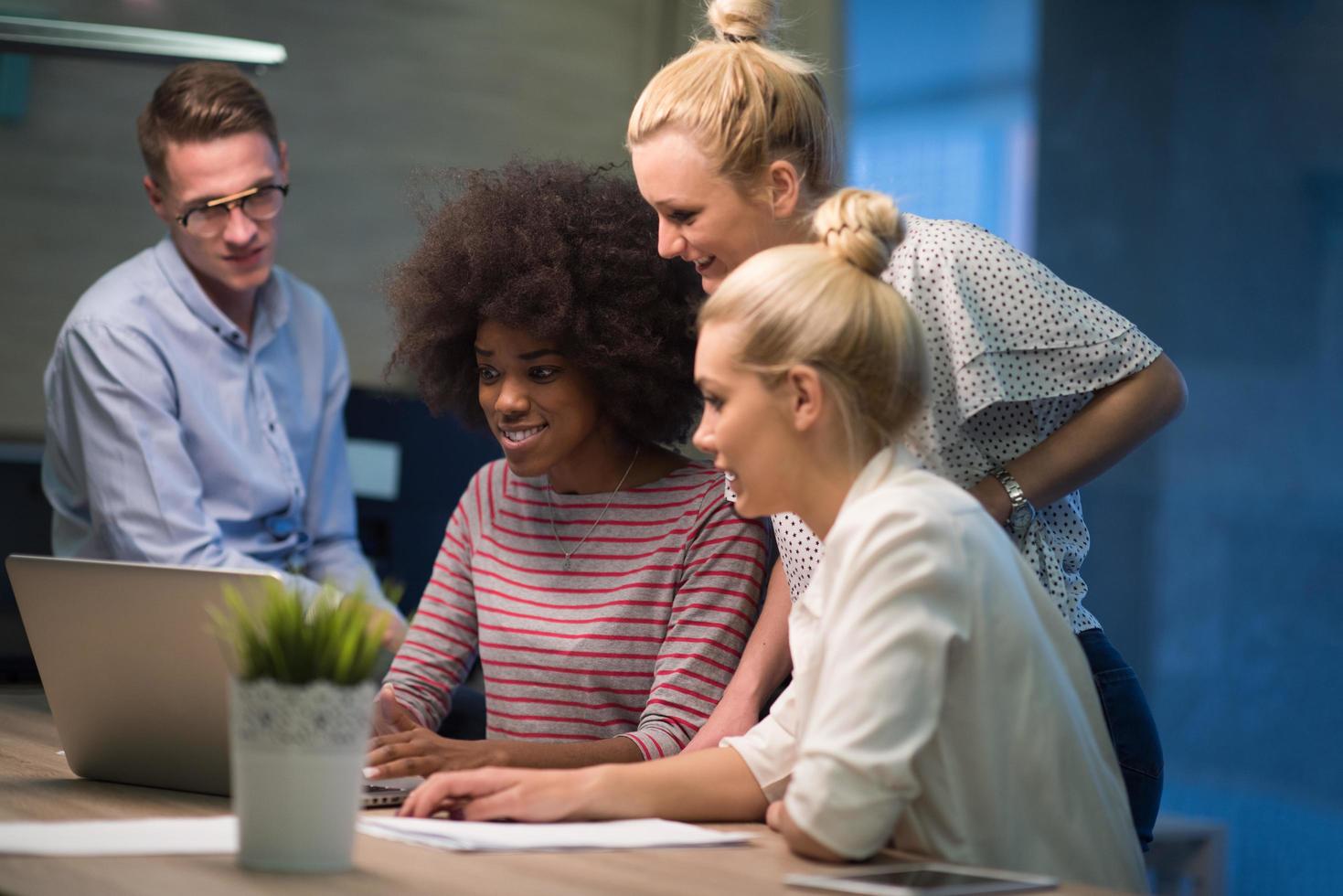 Multiethnic startup business team in night office photo