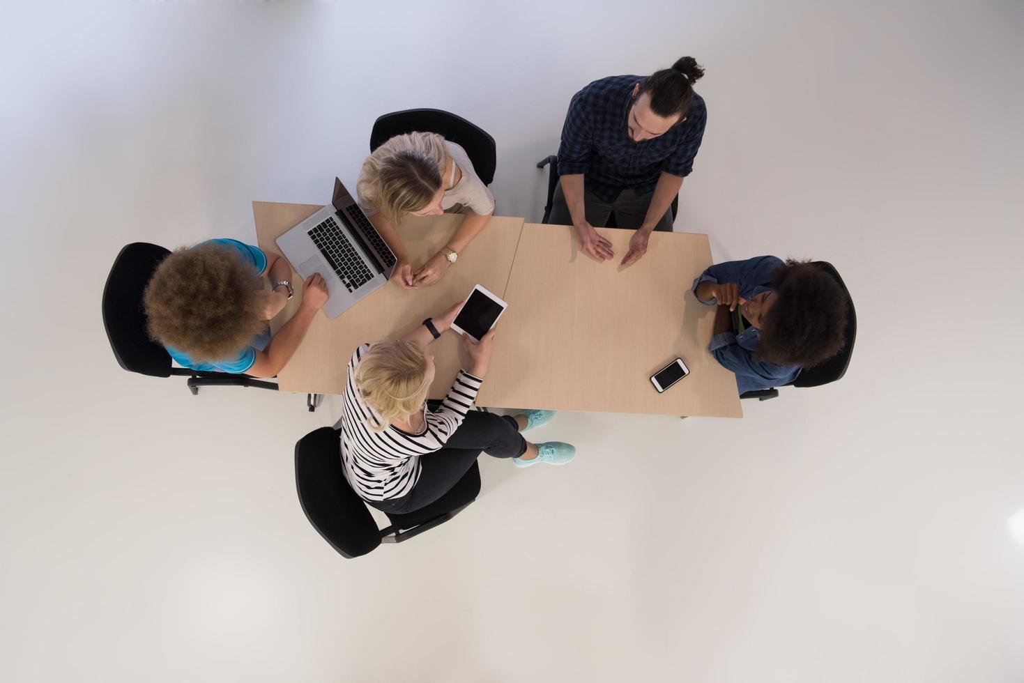 Multiethnic startup business team on meeting  top view photo