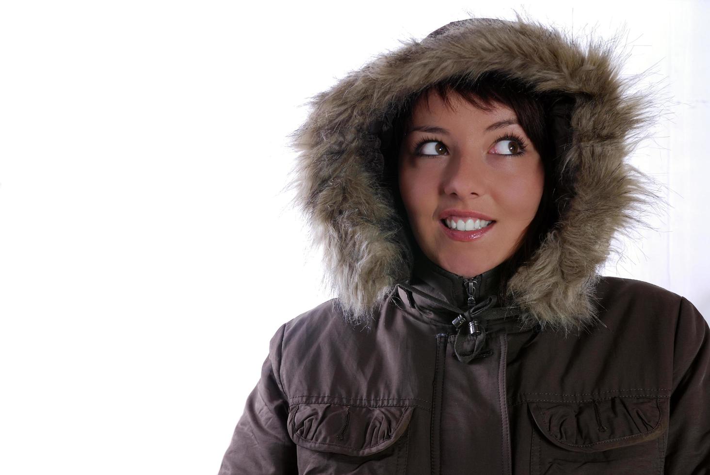 Cute young woman smiling in winter jacket photo