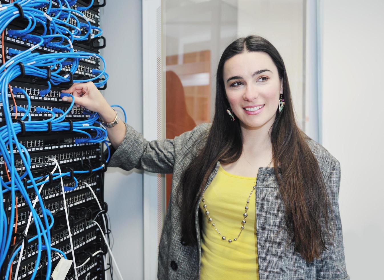 woman it engineer in network server room photo