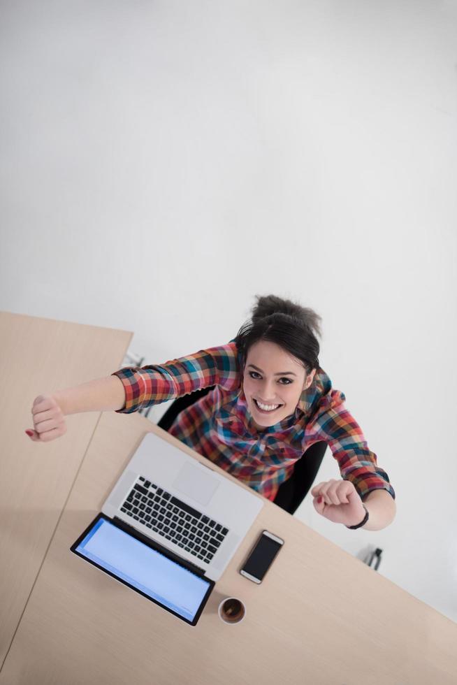 top view of young business woman working on laptop photo