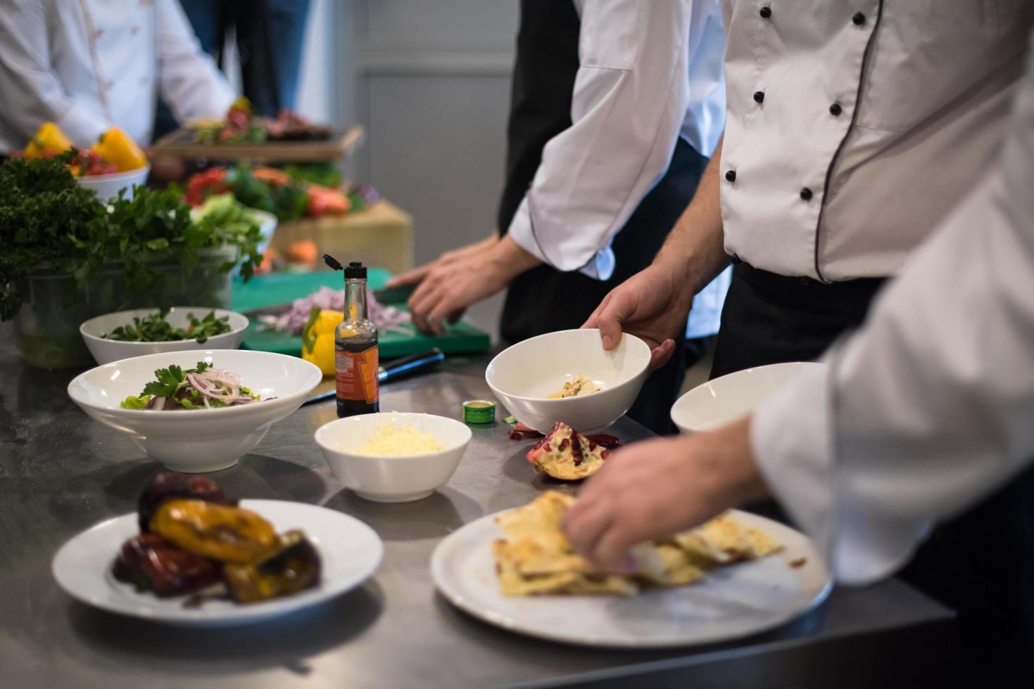 team cooks and chefs preparing meal photo