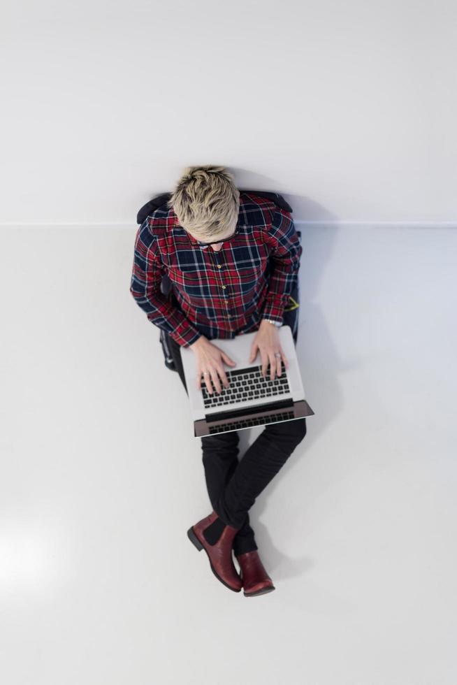 top view of young business woman working on laptop computer photo