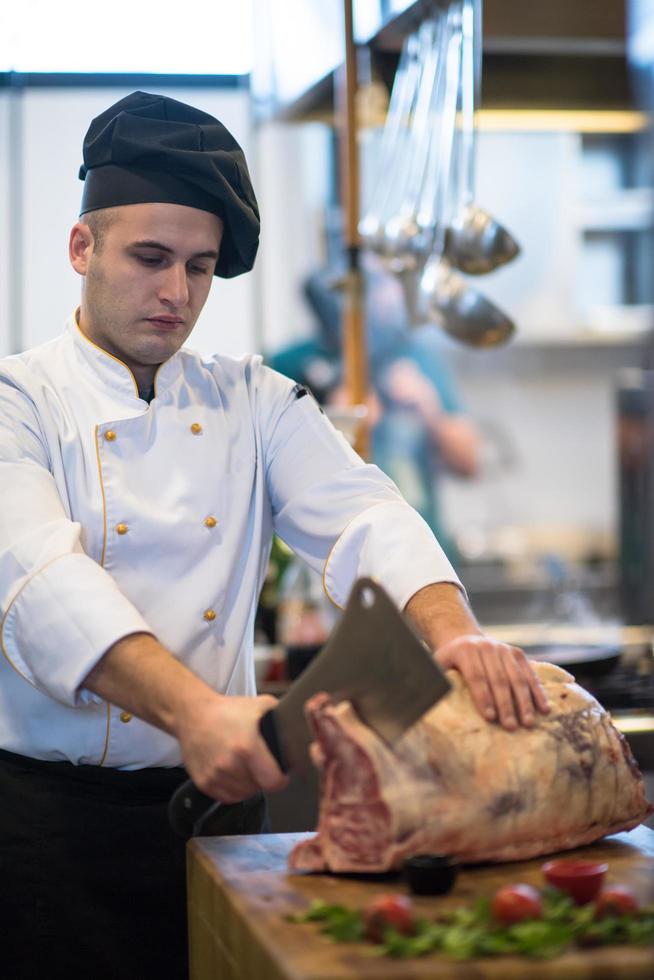 chef cutting big piece of beef photo