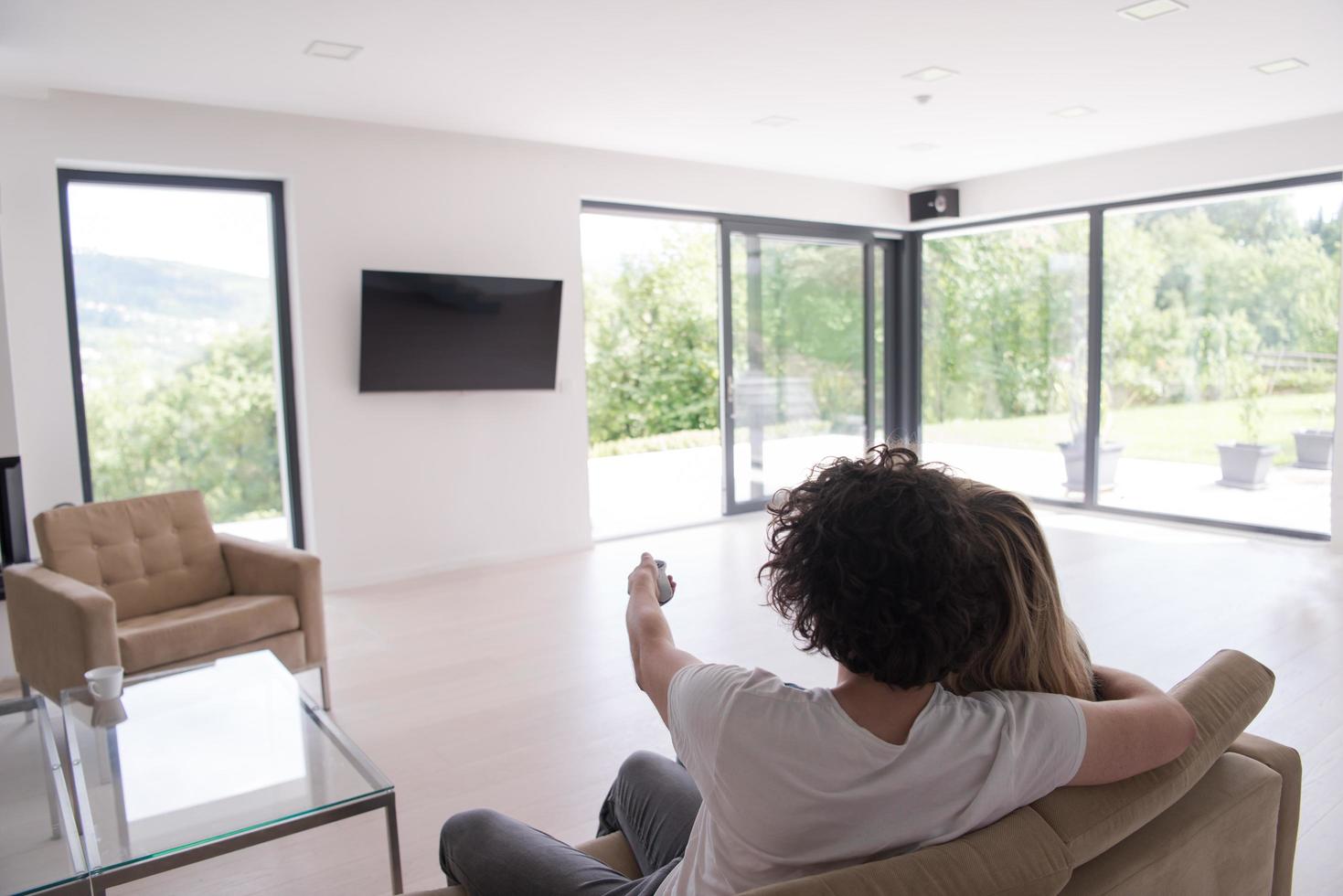 Rear view of couple watching television photo