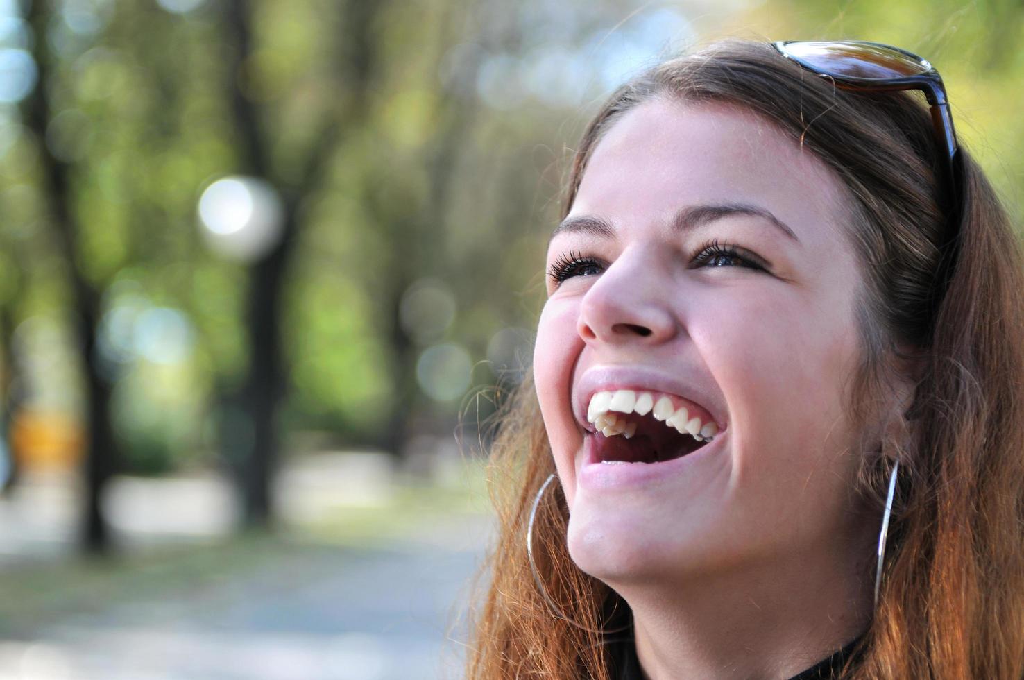 brunette Cute young woman smiling outdoors in nature photo