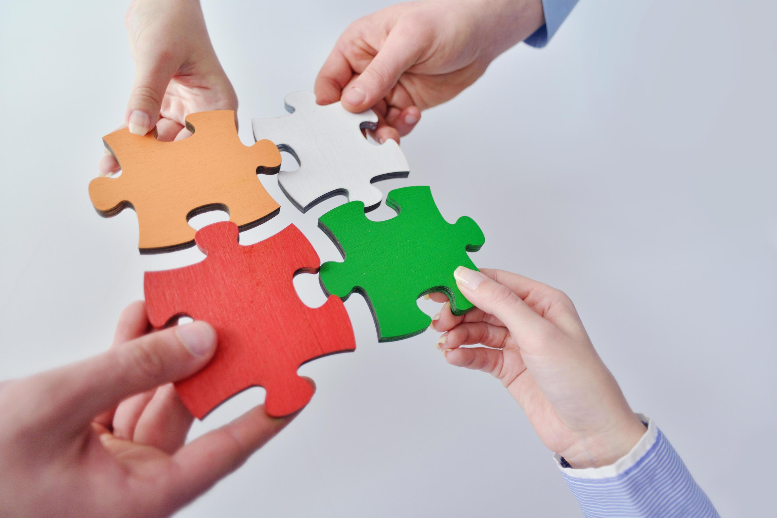 Group of business people assembling jigsaw puzzle 12097049 Stock Photo