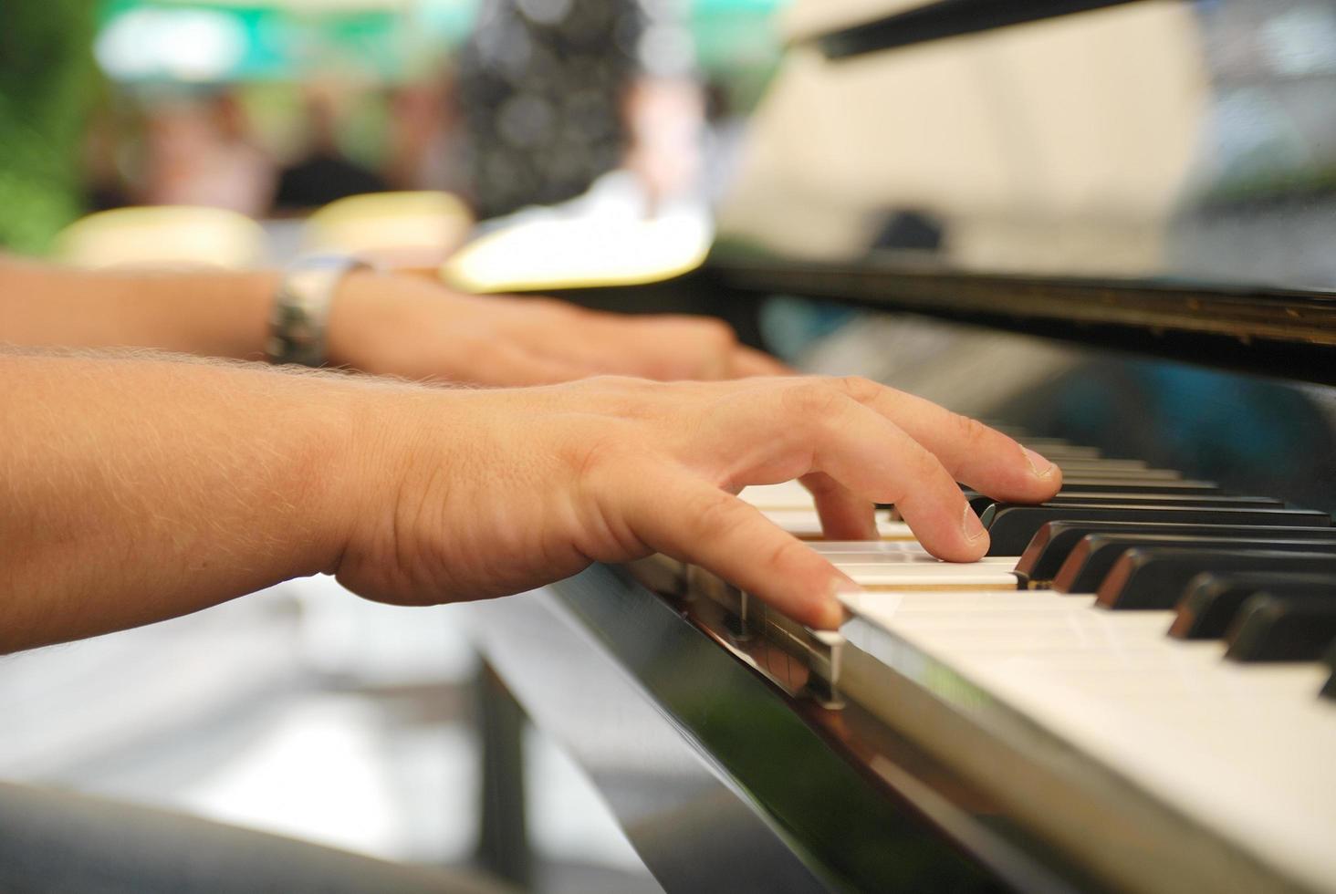 Man playing melody on piano photo