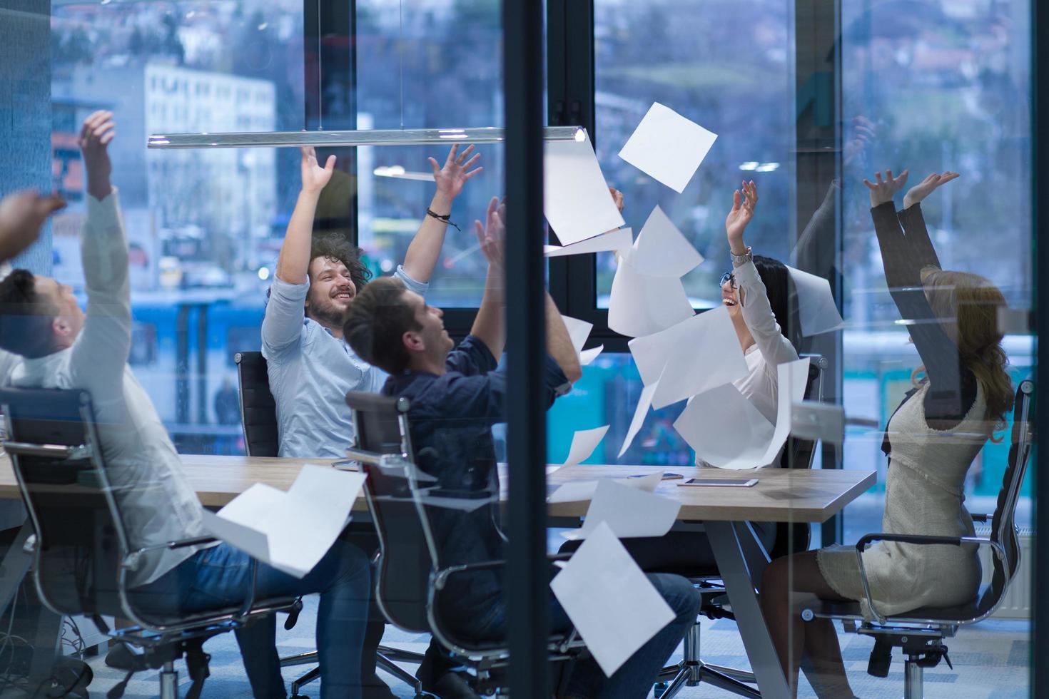 startup Group of young business people throwing documents photo