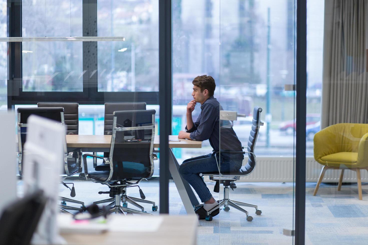 young businessman relaxing at the desk photo