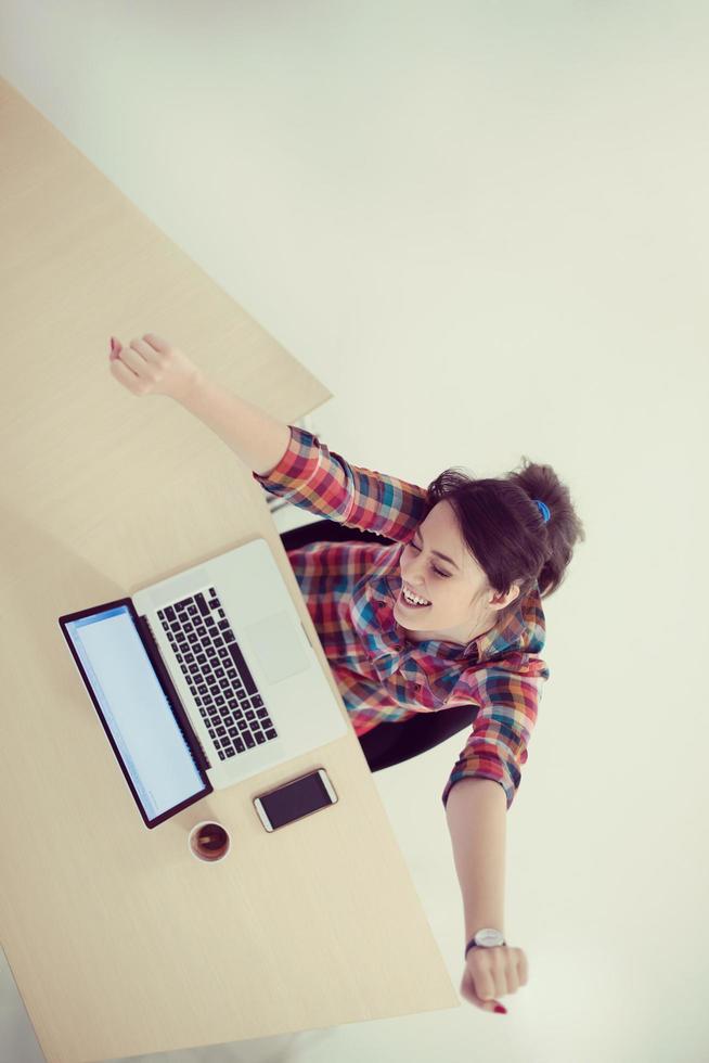 top view of young business woman working on laptop photo