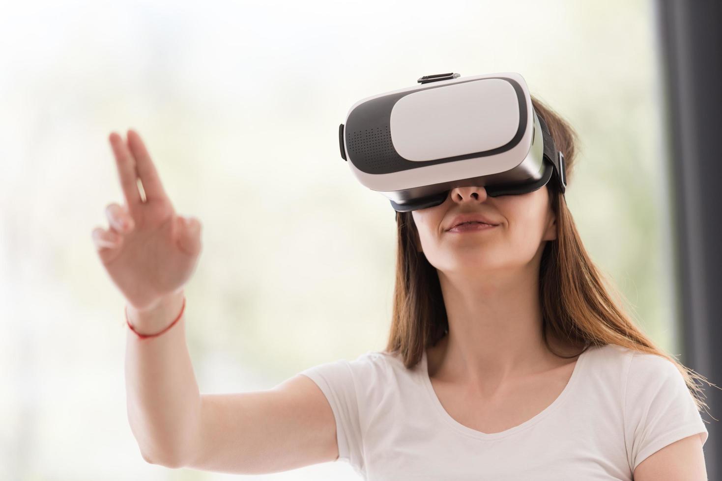 woman using VR-headset glasses of virtual reality photo