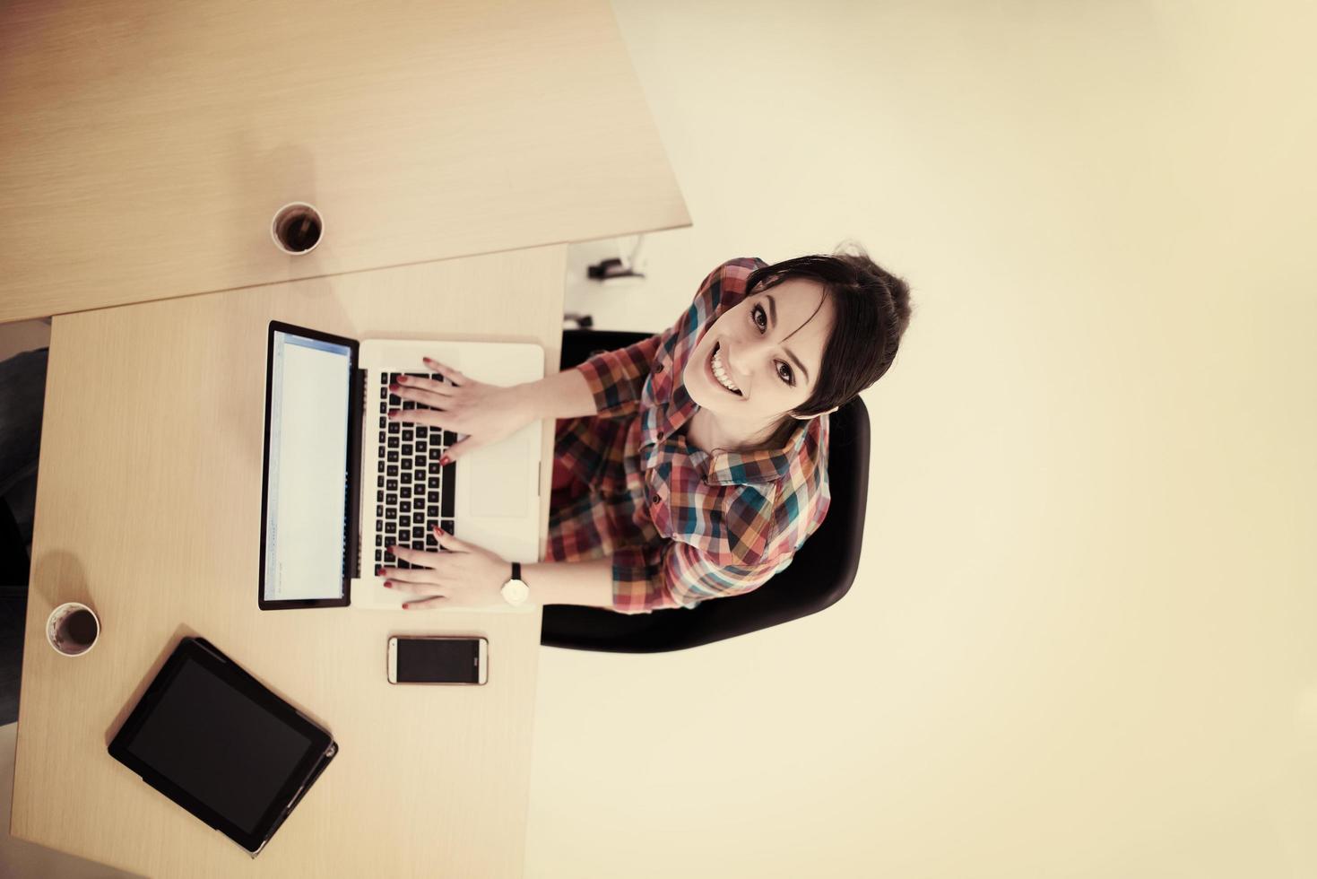 top view of young business woman working on laptop photo