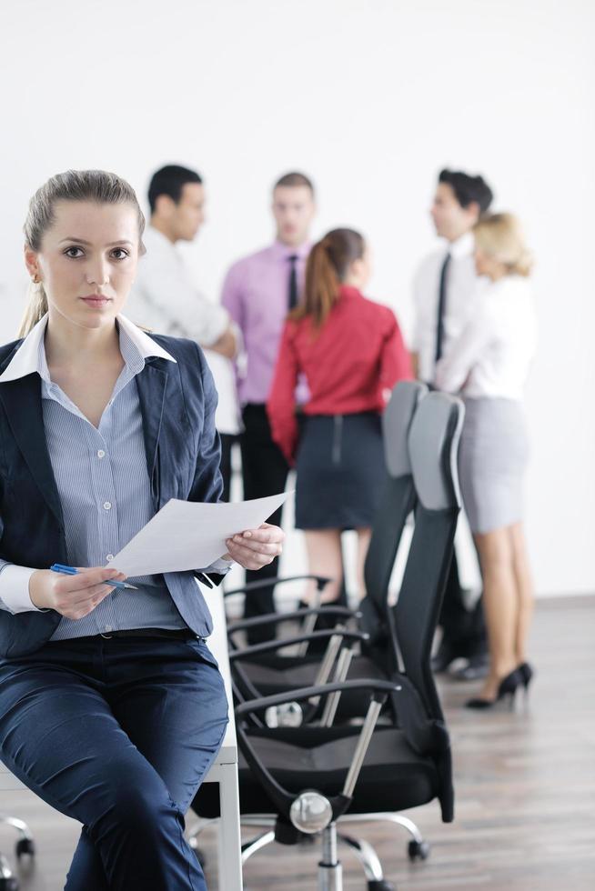 business woman standing with her staff in background photo