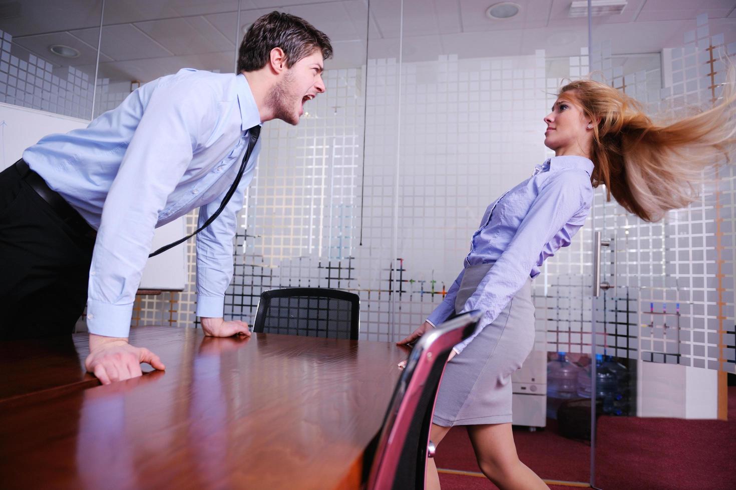 Angry busines sman screaming at employee photo