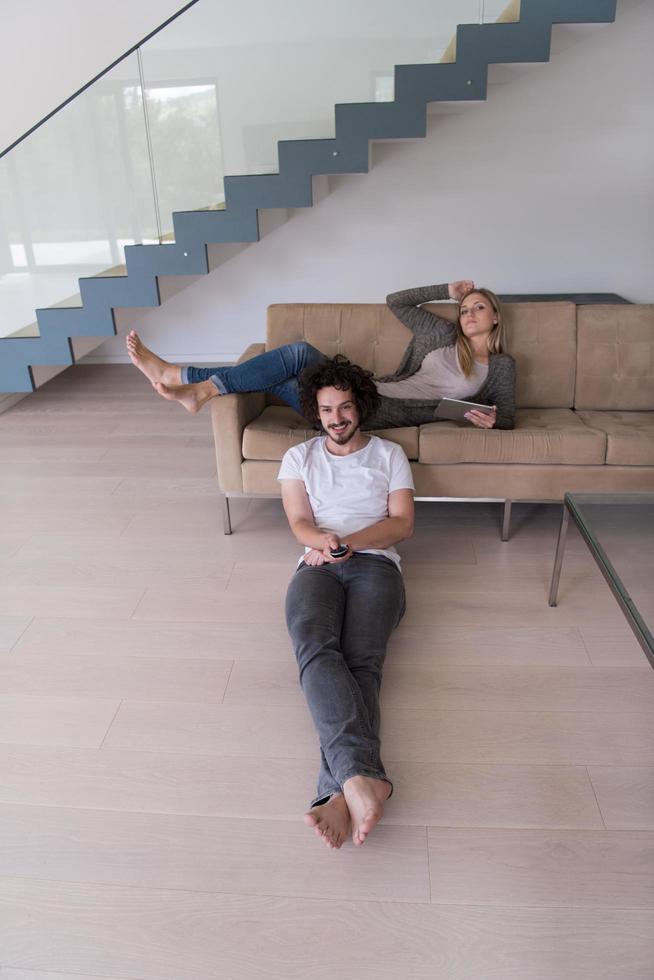 young couple relaxes in the living room photo