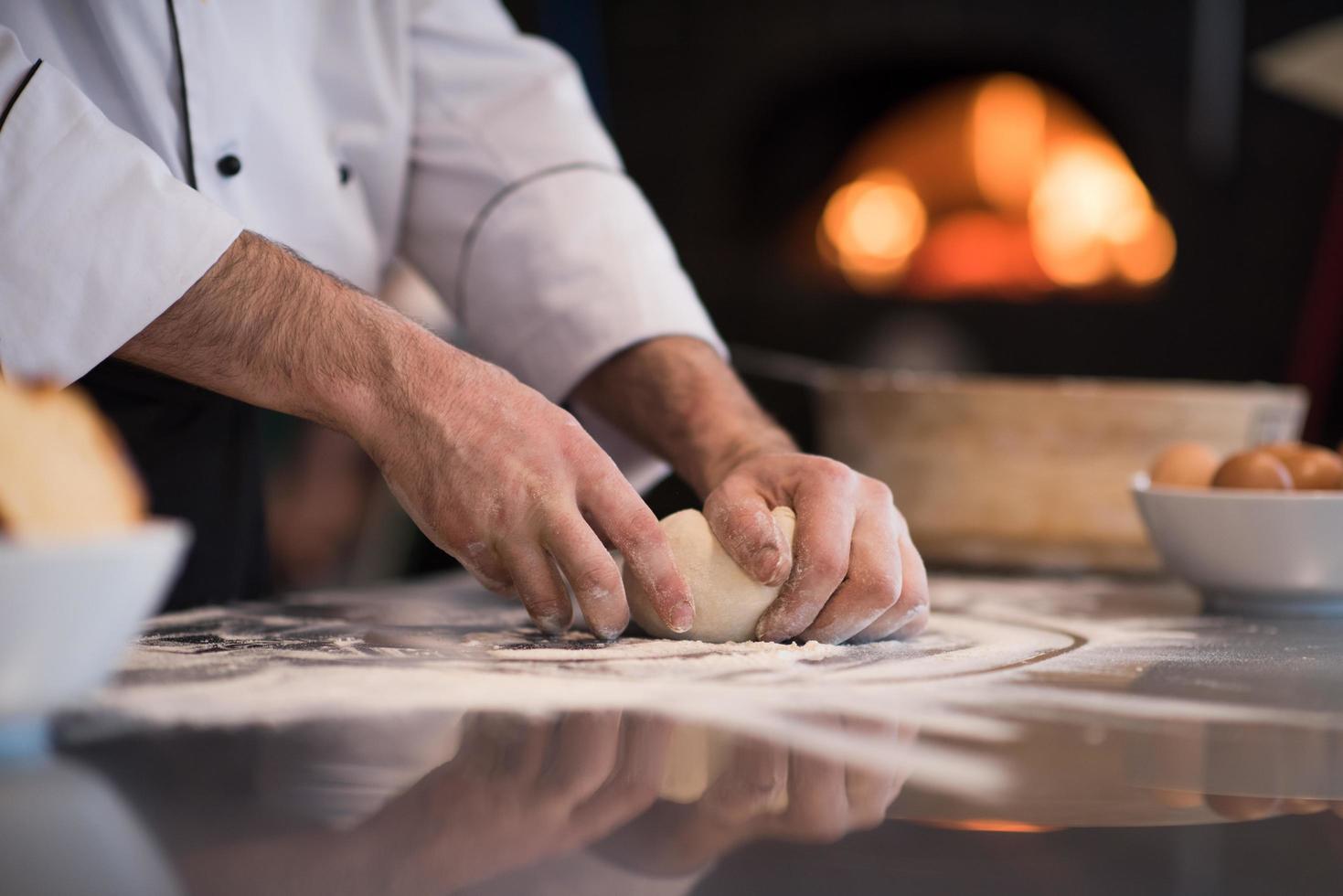 chef hands preparing dough for pizza photo