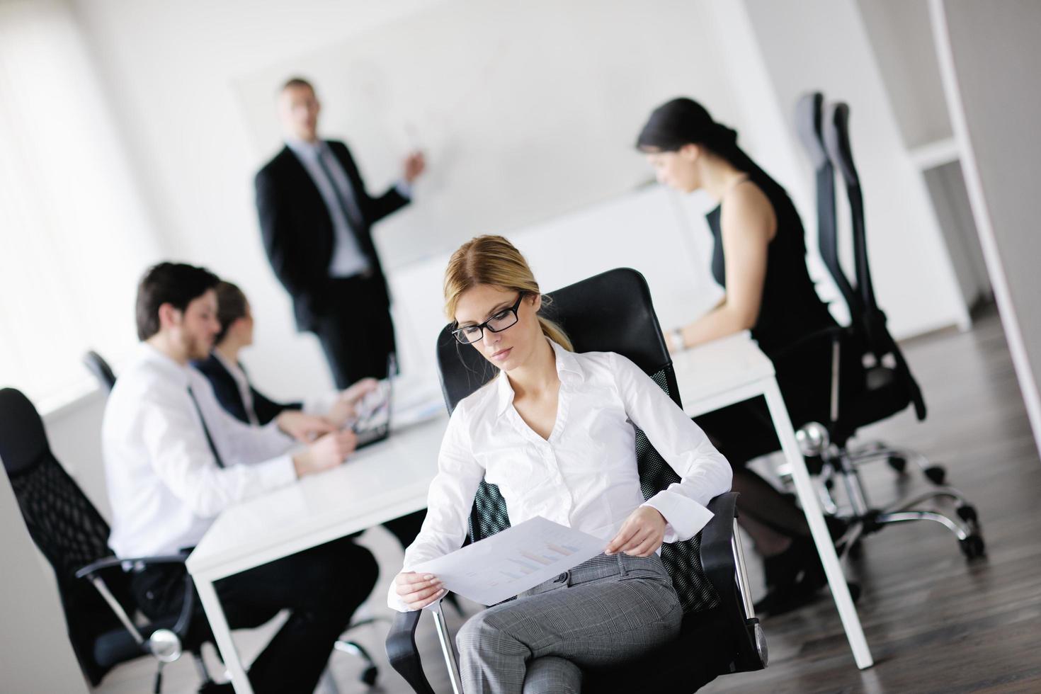 business woman with her staff in background photo