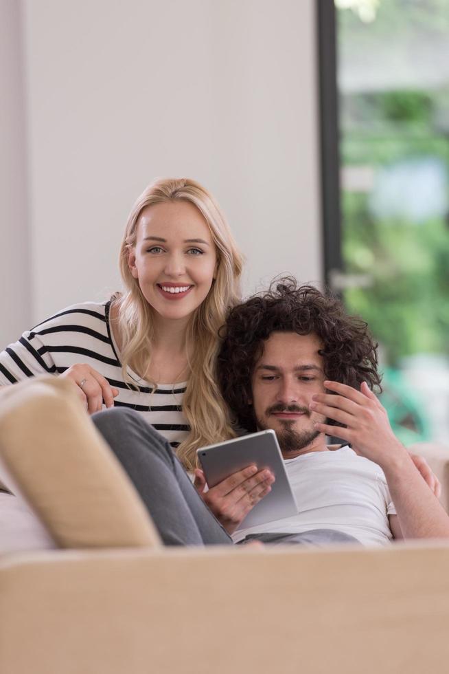 couple relaxing at  home with tablet computers photo