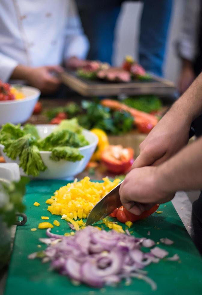Chef hands cutting fresh and delicious vegetables photo