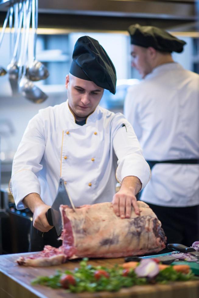 chef cutting big piece of beef photo