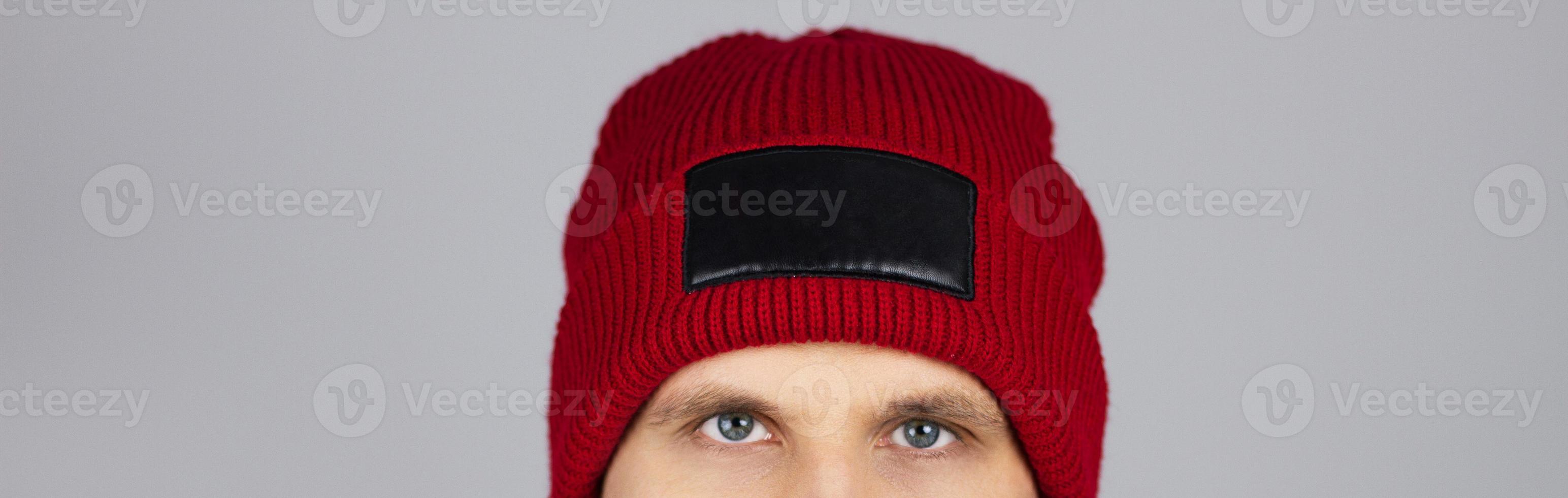 hipster in red blank hat isolated on grey photo