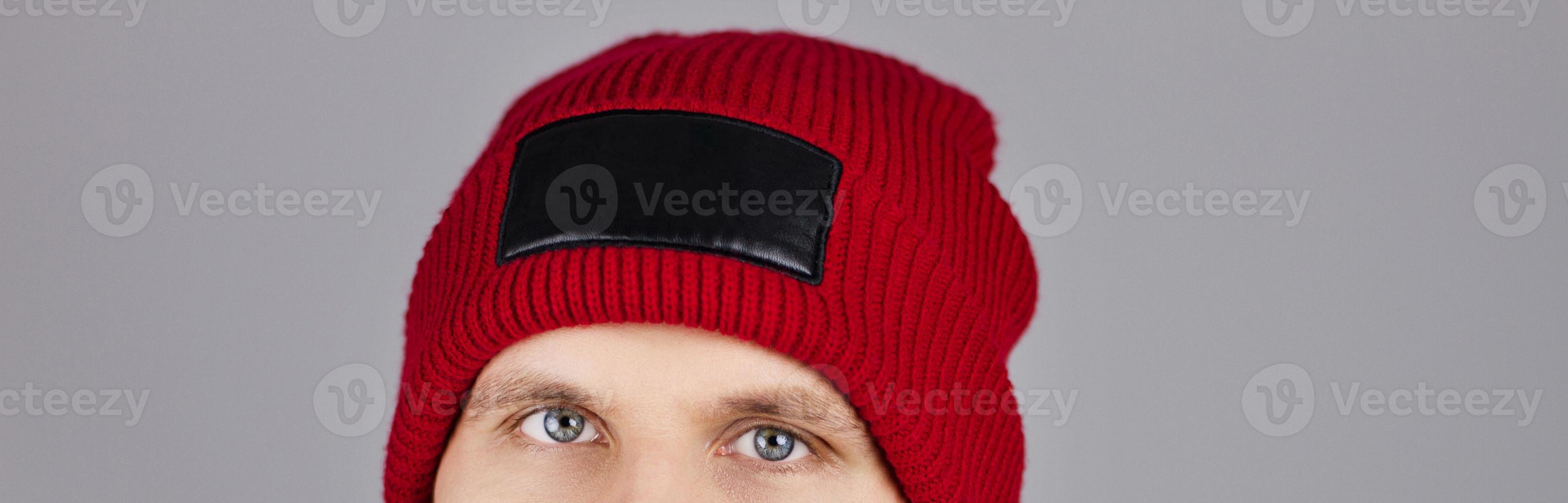 hipster in red winter hat isolated on grey background, blank,empty - cropped image photo
