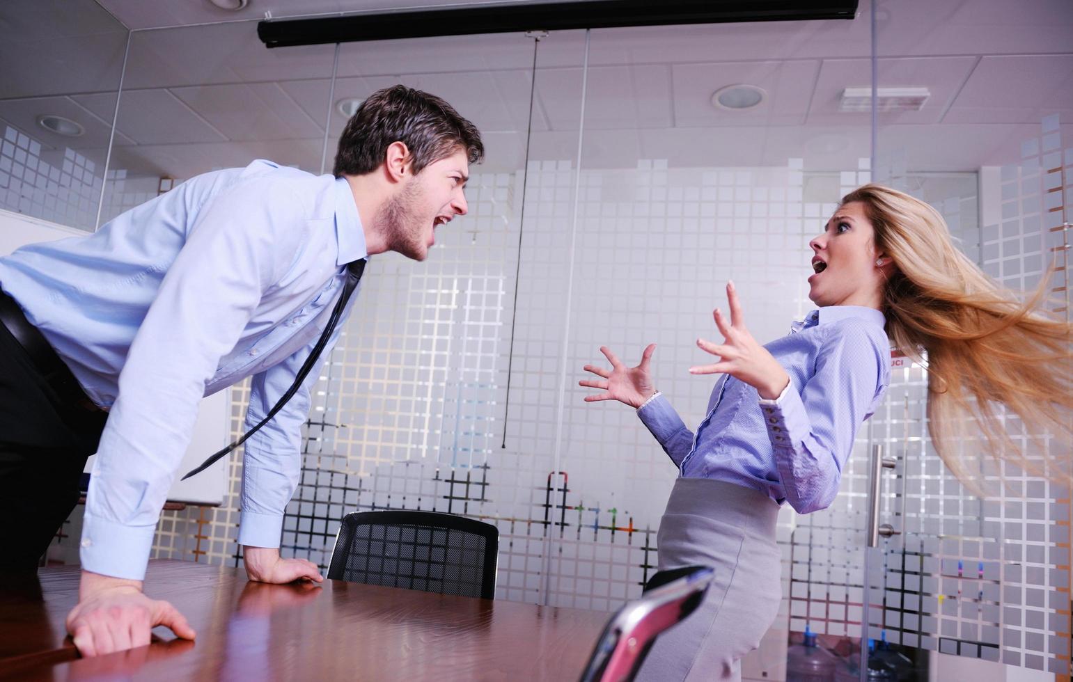Angry busines sman screaming at employee photo