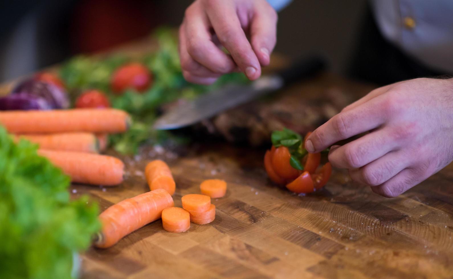 closeup of Chef hands preparing beef steak photo