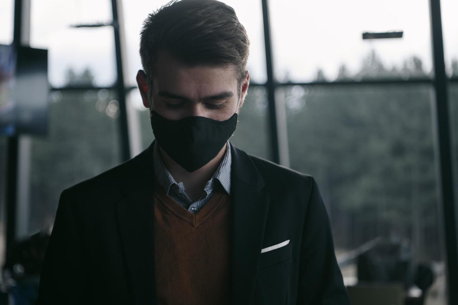 business man wearing protective face mask at luxury office photo