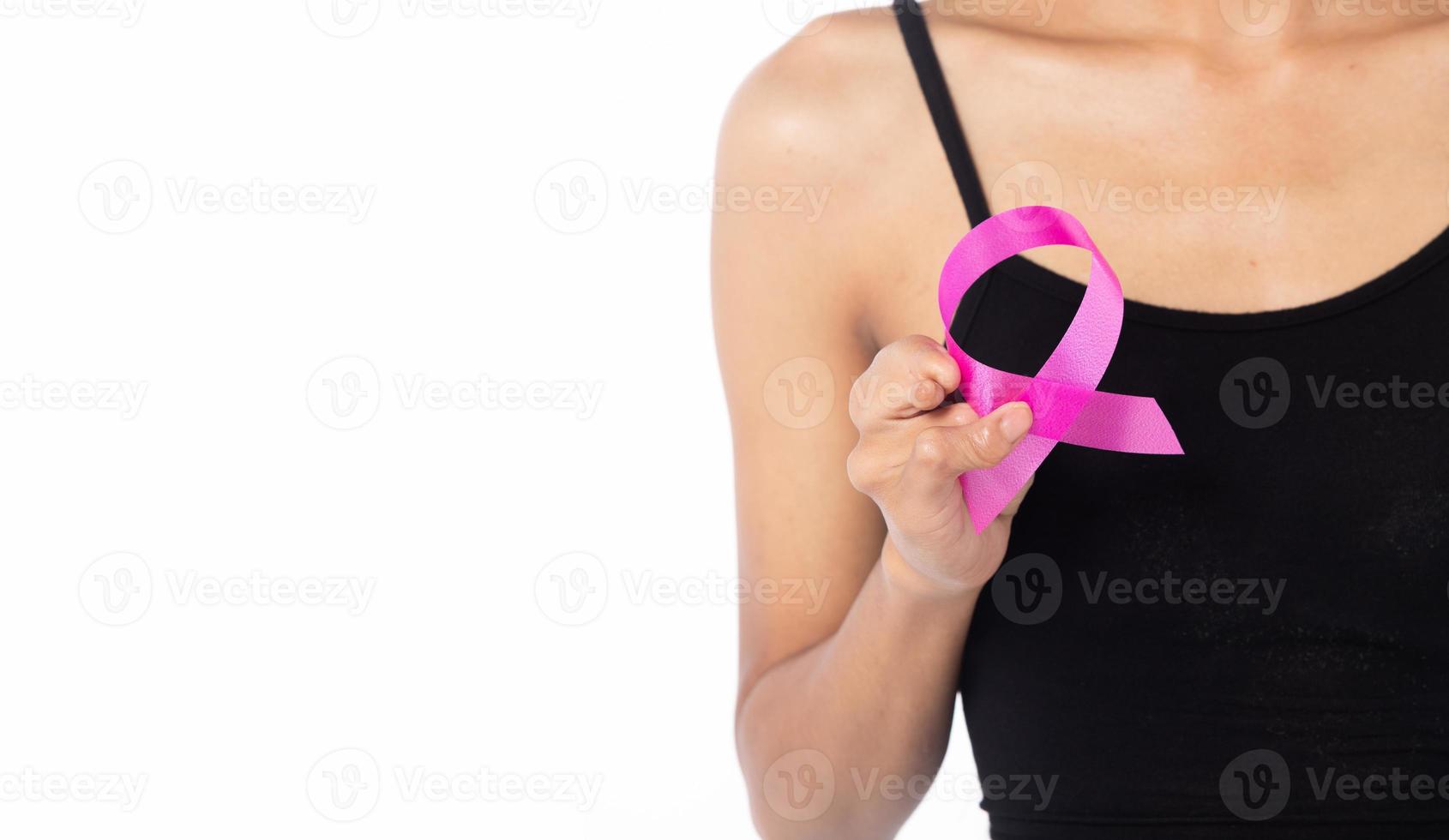 October Breast Cancer Awareness month, tanned skin Disability Woman hand hold Pink Ribbon for supporting people world campaign. International Women, Mother and World cancer day concept copy space photo