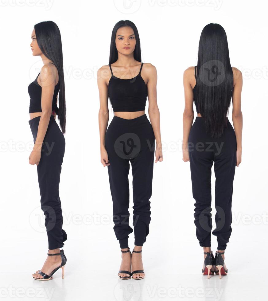 Full length tanned skin women with disability of young adult stand confident, white background isolated. Asian female long straight hair smile in black shirt dress pant high heel shoes, 360 profile photo
