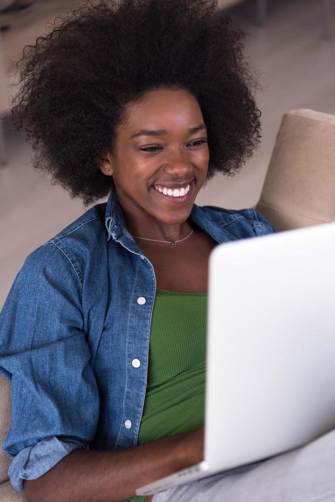 African American women at home in the chair using a laptop photo