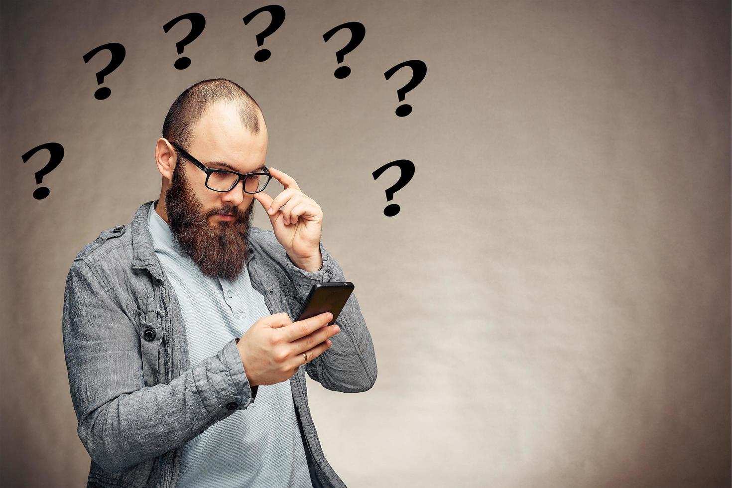 lifestyle brooding man with a beard and a telephone, background, copyspace photo