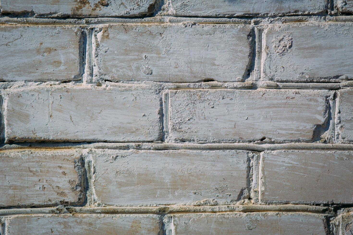 Abstract weathered texture stained old stucco light gray and aged paint white brick wall background in rural room, grungy rusty blocks of stonework technology color horizontal architecture wallpaper photo