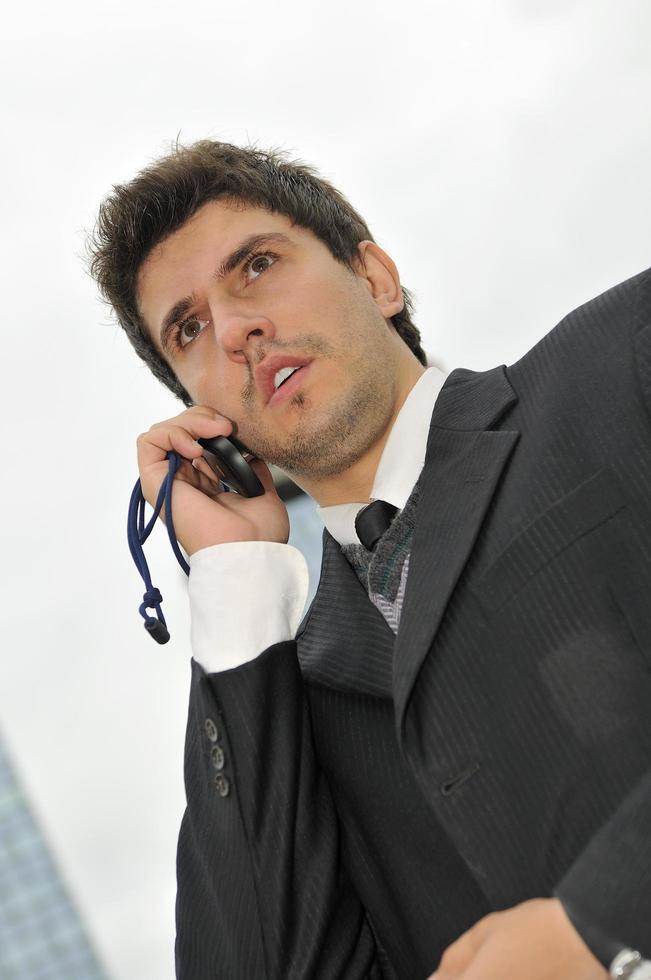 Photo of happy winner businessman  talking on mobile phone