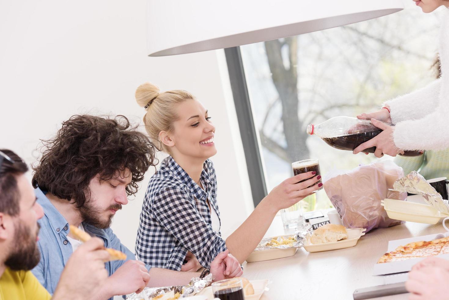 multiethnic group of happy friends lunch time photo