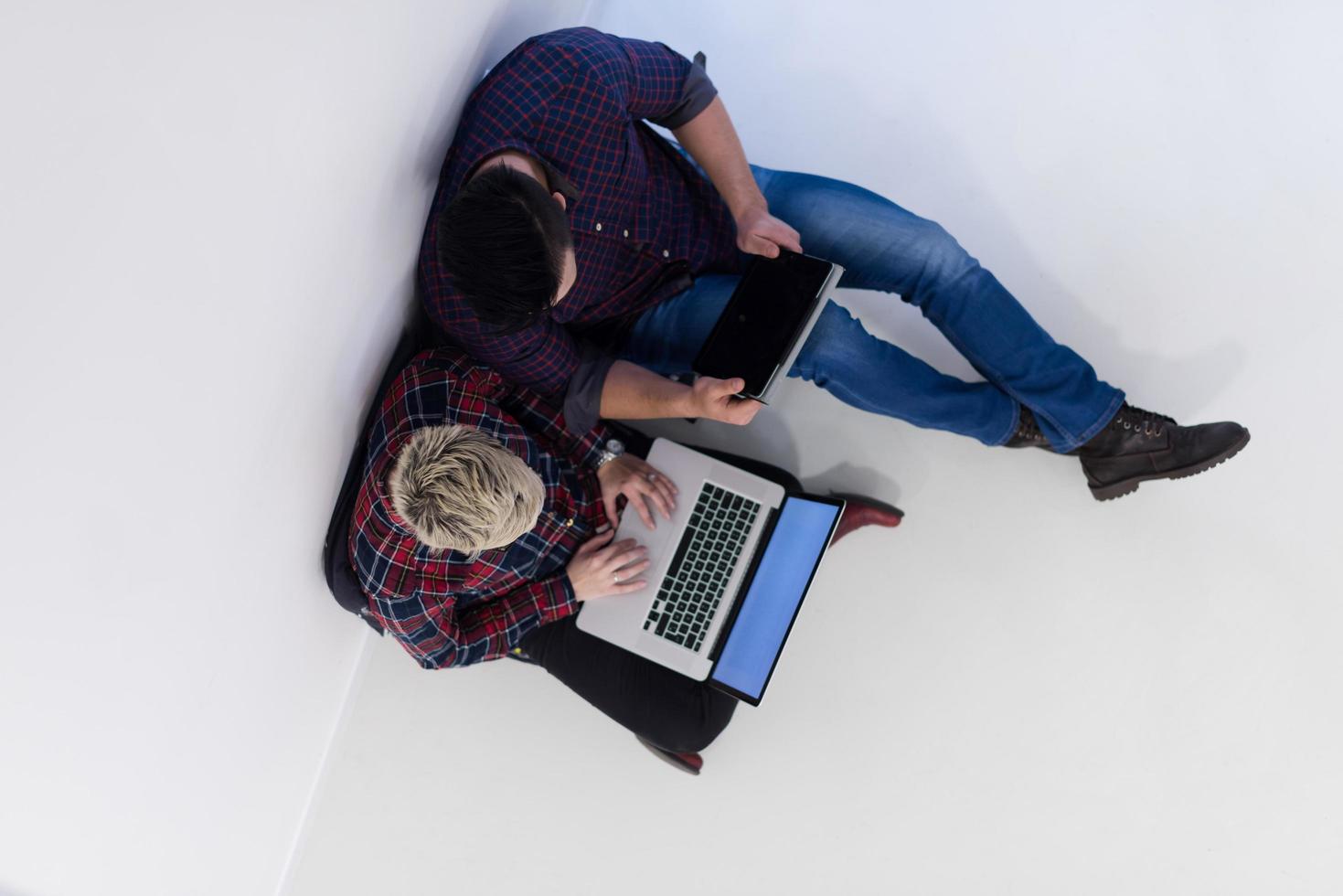 top view of  couple working on laptop computer at startup office photo