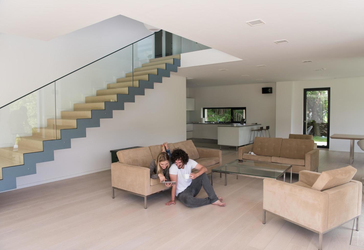 couple relaxing at  home with tablet computers photo