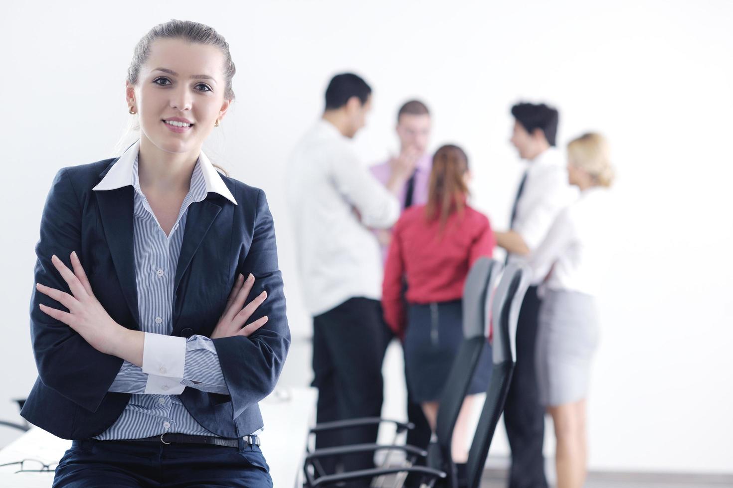 business woman standing with her staff in background photo