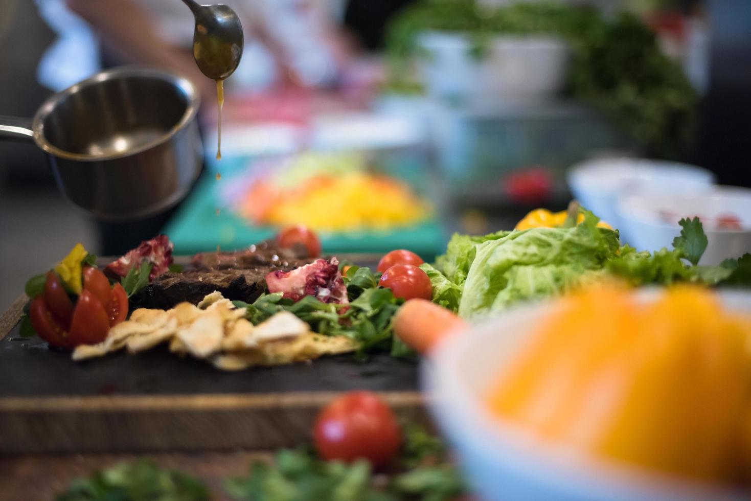 Chef hand finishing steak meat plate photo