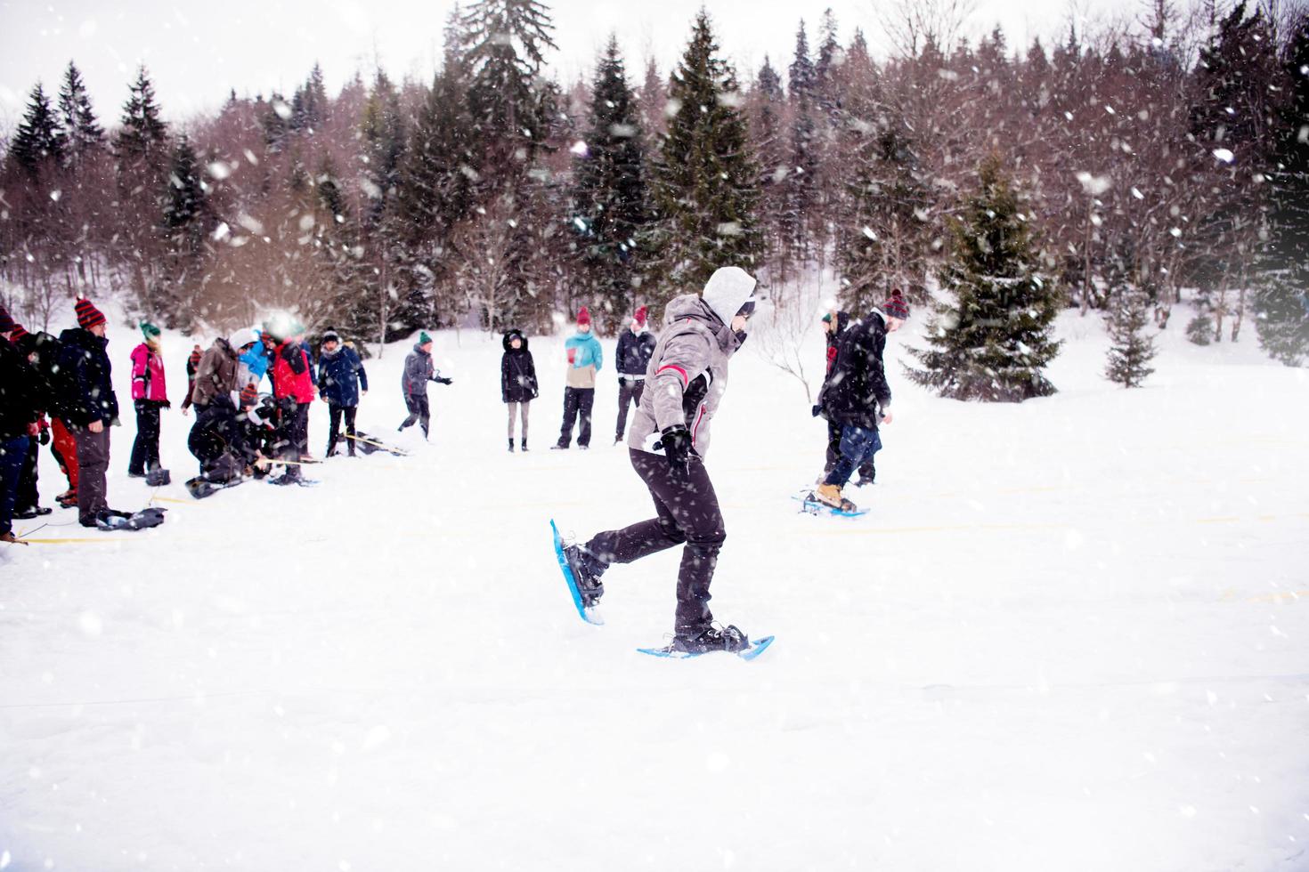 group of young people having a running competition on winter day photo