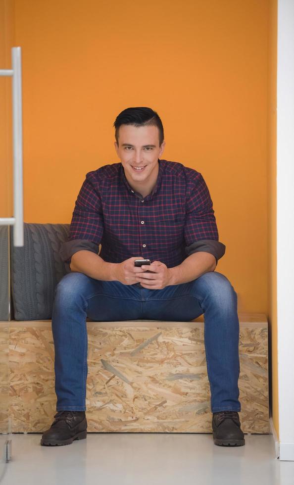 man in crative box working on smart phone photo