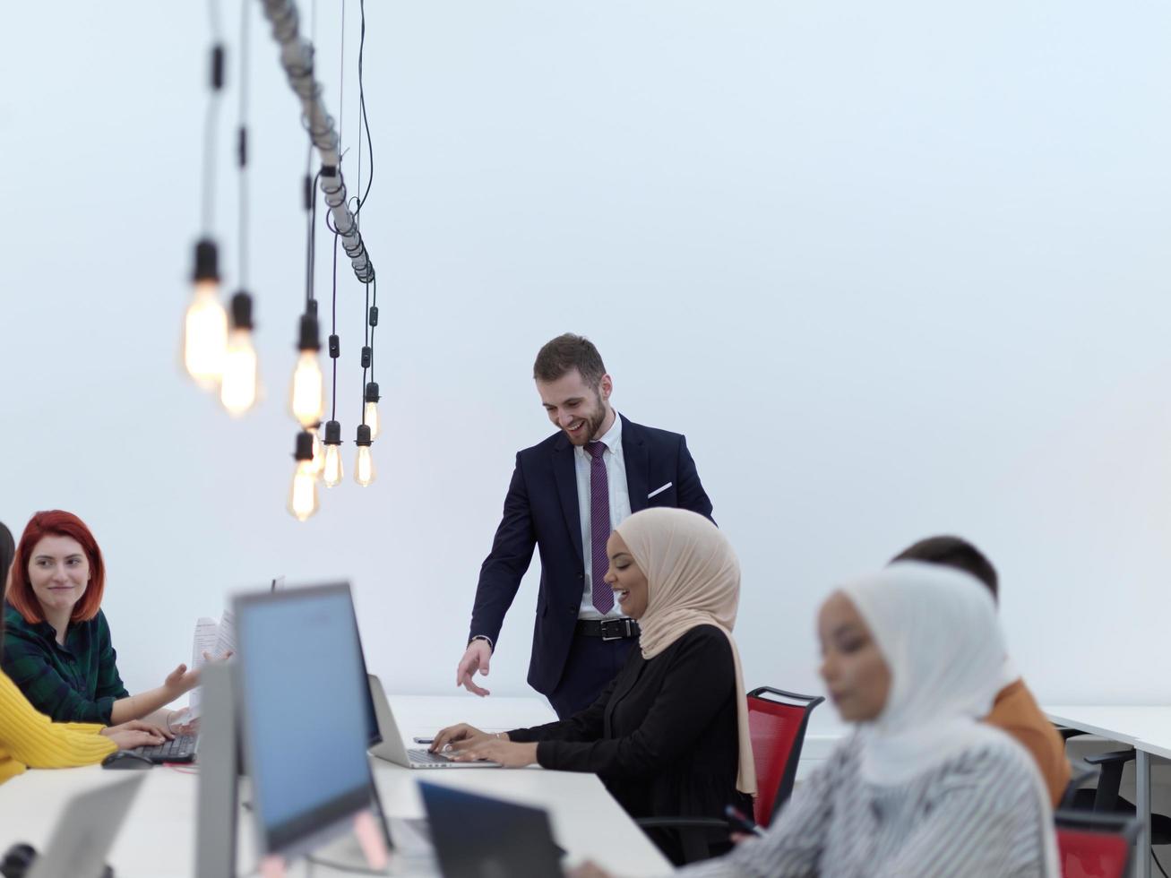 creative business people group as freelancers in modern coworking open space office photo